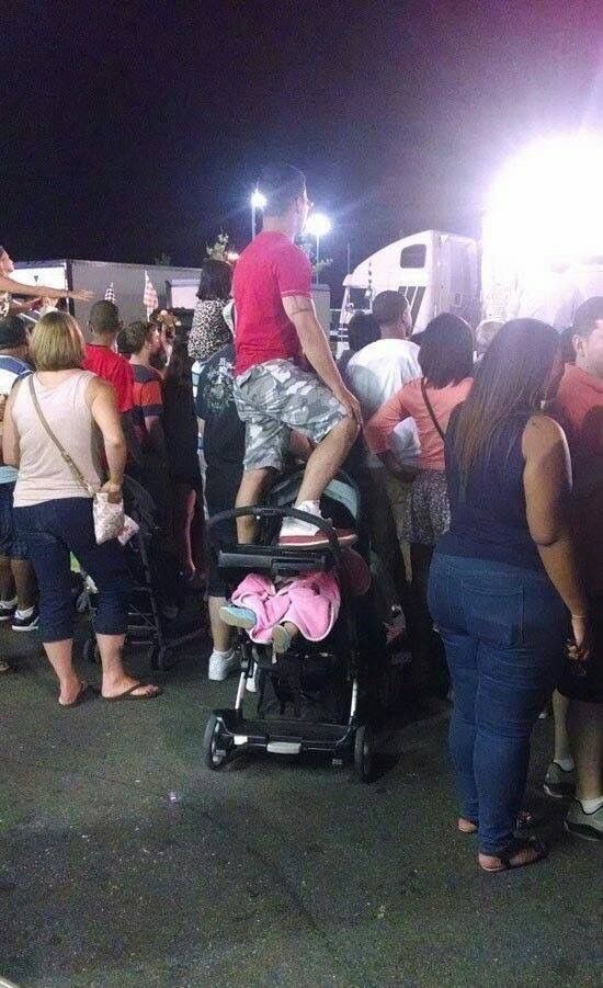 Dad Standing On His Kid’s Stroller