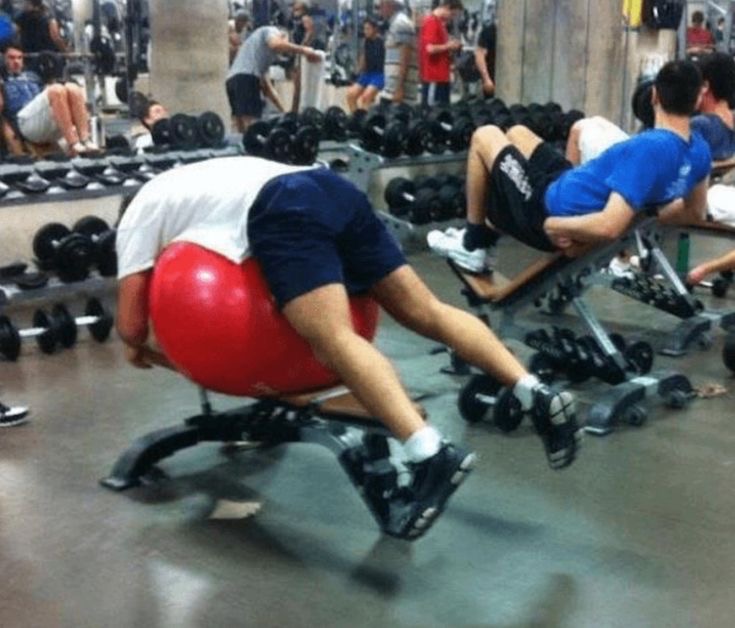 Man Places a Pilates Ball on a Gym Machine