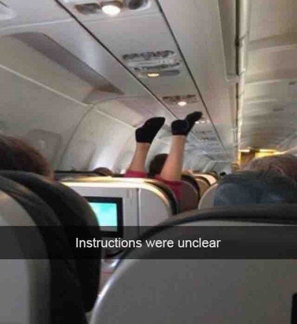 Man Upside Down in Airplane Seat