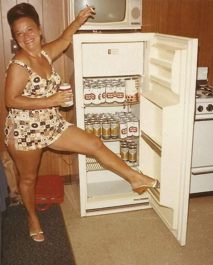 Woman With a Fridge Packed Only With Beer Cans