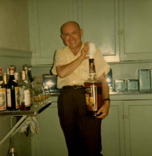 Grandpa Holding an Oversized Bottle of Whiskey