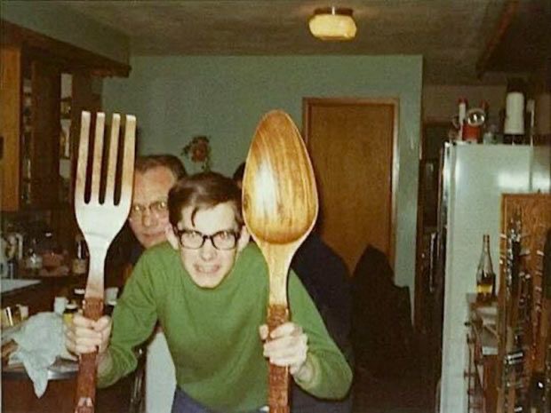 Boy Holding Giant Spoon and Fork