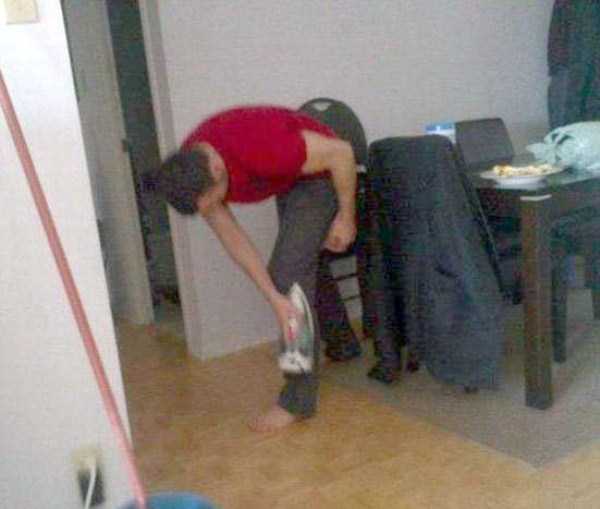 Ironing out clothes on himself