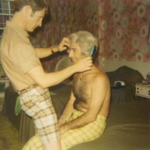 Man in a White Wig Getting His Hair Styled