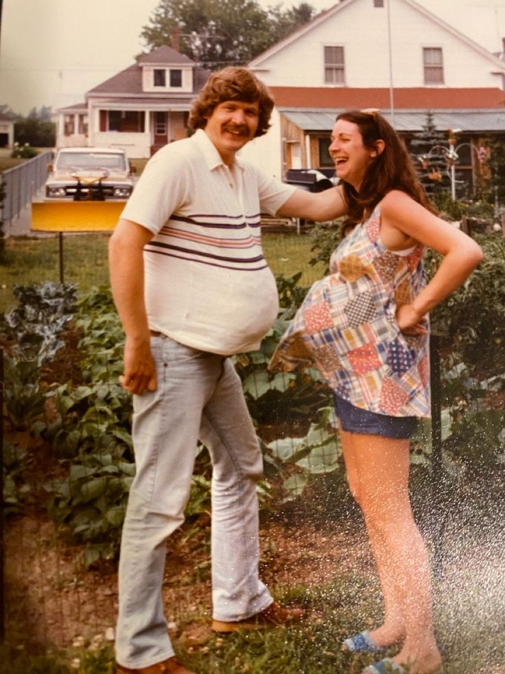Pregnant Mom and Dad Showing Off Matching Bellies