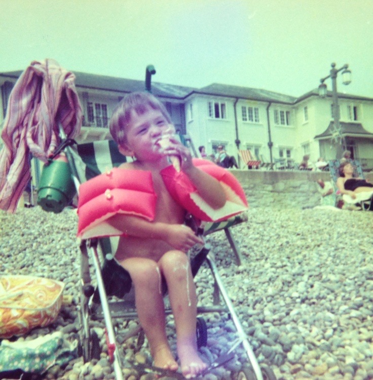 Kid in Floaties Eating Ice Cream
