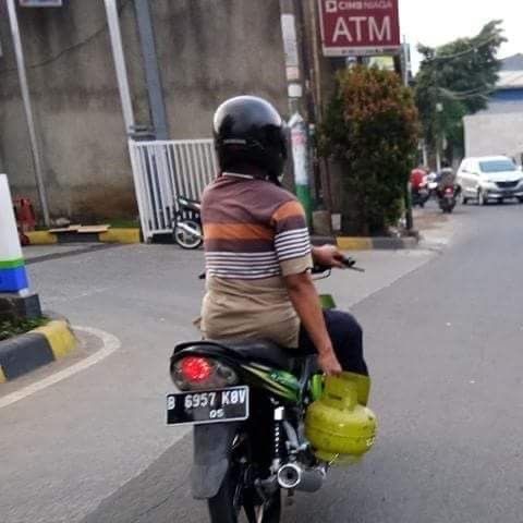 Motorcycle Guy Transporting a Tiny Gas Tank