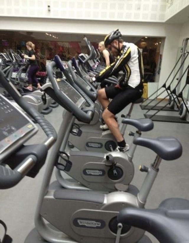 Man Wearing Full Cycling Gear on a Gym Bike
