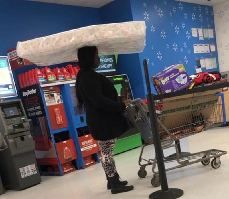 Lady Balances a Mattress on Her Head