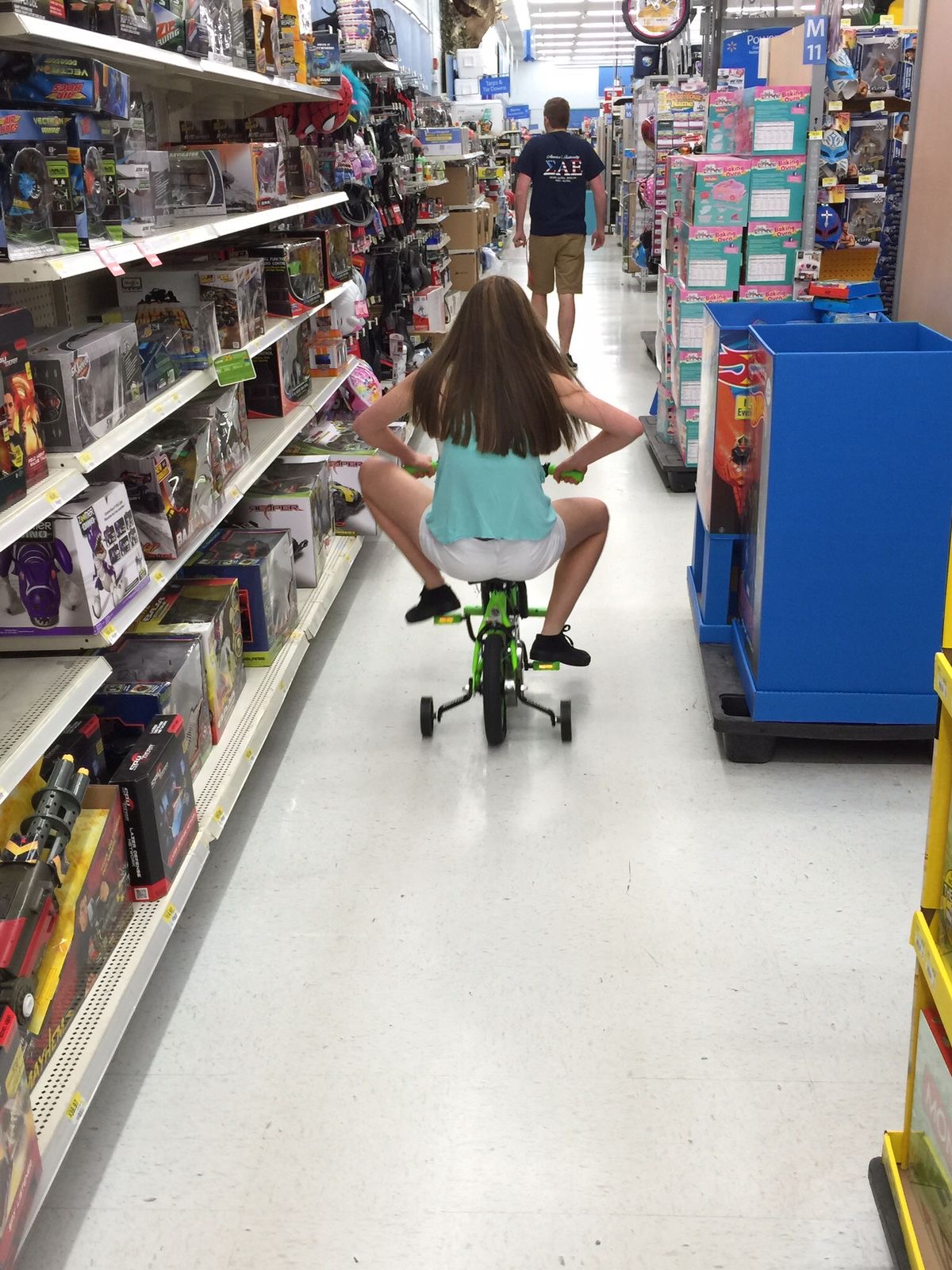 Little Girl Pedals Her Bike Down Walmart’s Aisles