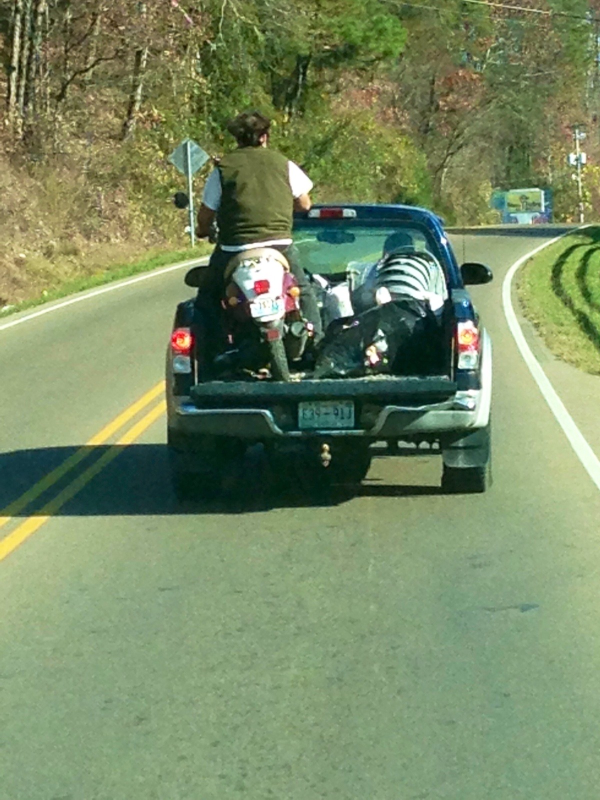 Man On His Bike on the Back of a Moving Truck