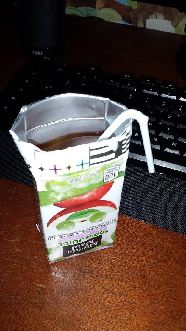 Person Opens Juice Box from the Bottom