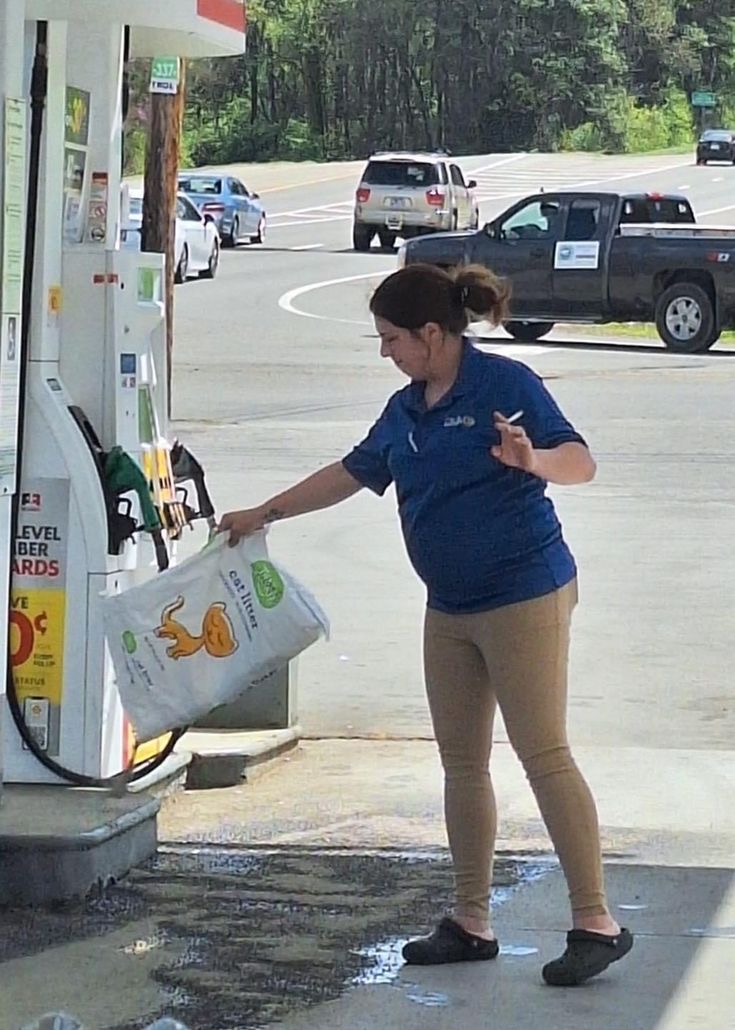 Woman Smoking While Filling Gas
