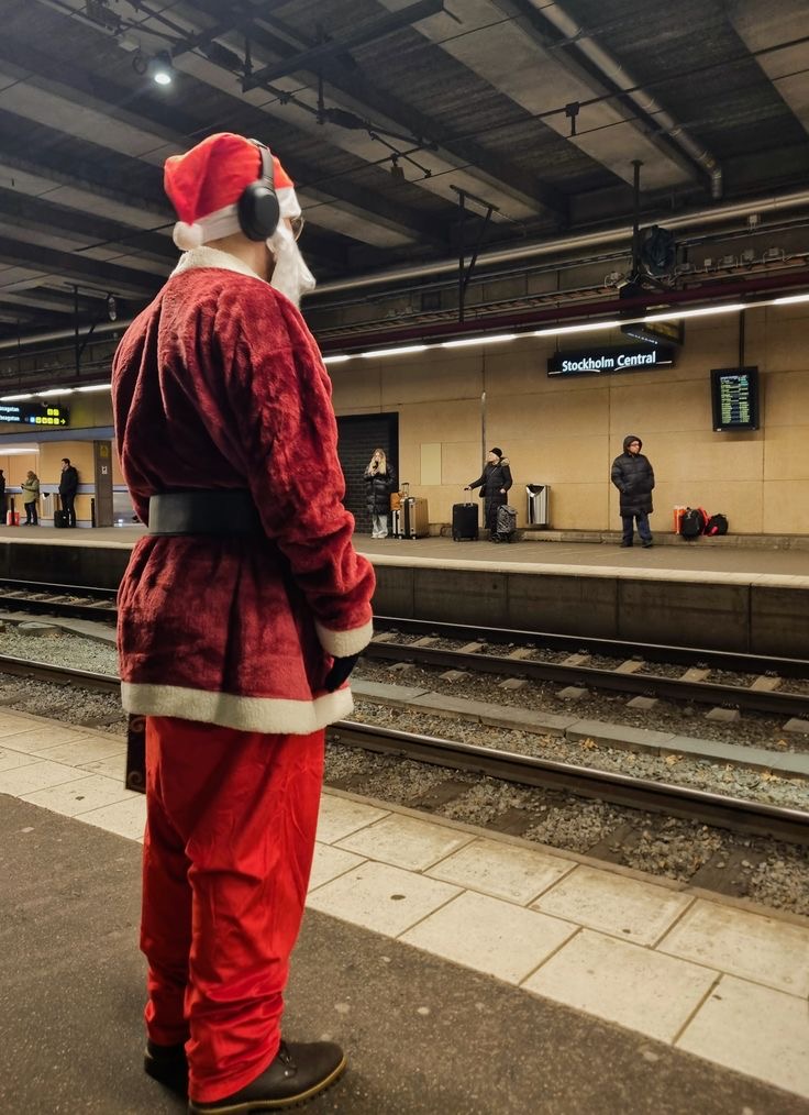 Santa Waiting for the Train with Headphones On