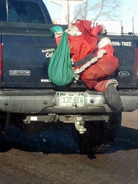 Dirty Santa Doll Climbing a Pickup Truck