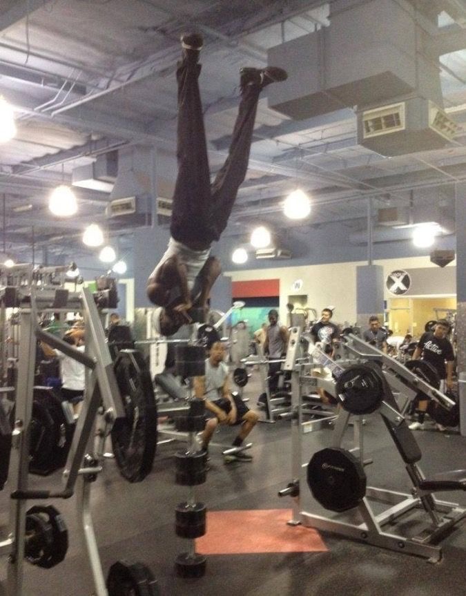 Man Standing on Stacked Weights