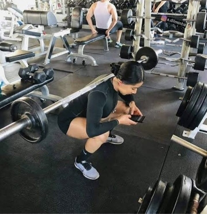 Weights on Her Back While on Her Phone