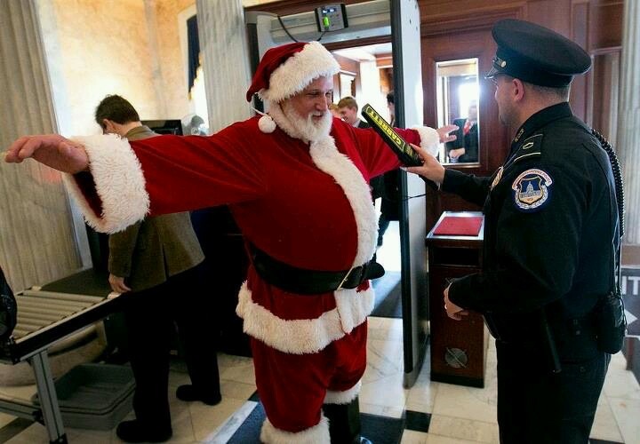 Santa Being Searched with a Metal Detector