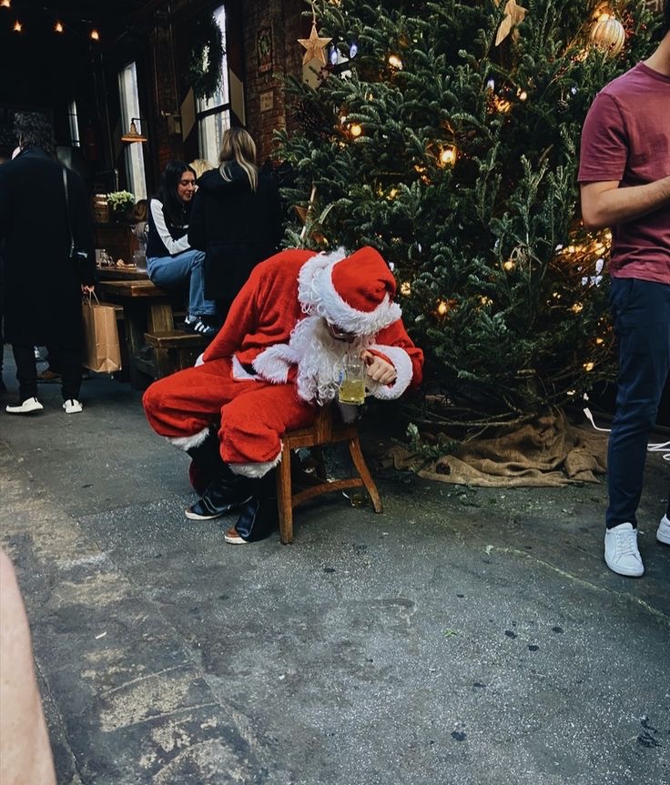 Santa Drinking Beer in Front of the Christmas Tree