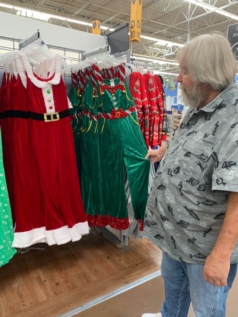 Man Studying Santa and Elf Costumes