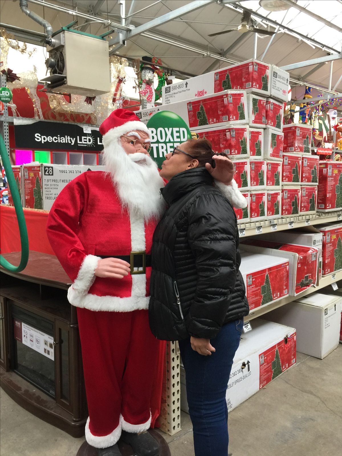Woman Trying to Kiss a Santa Doll