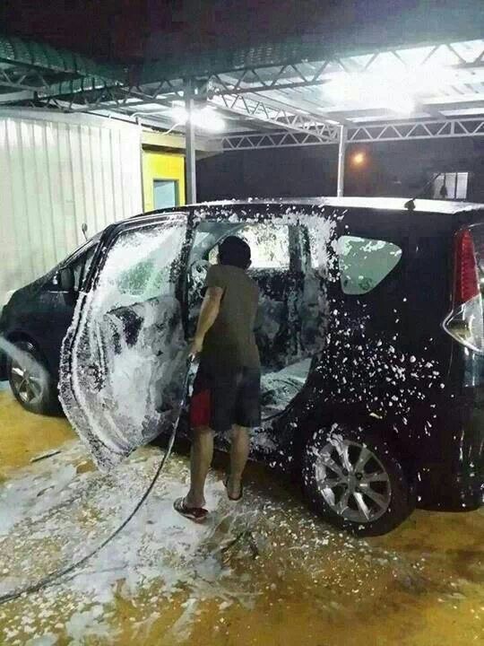 Man Washing the Inside of His Car With Soap and Water