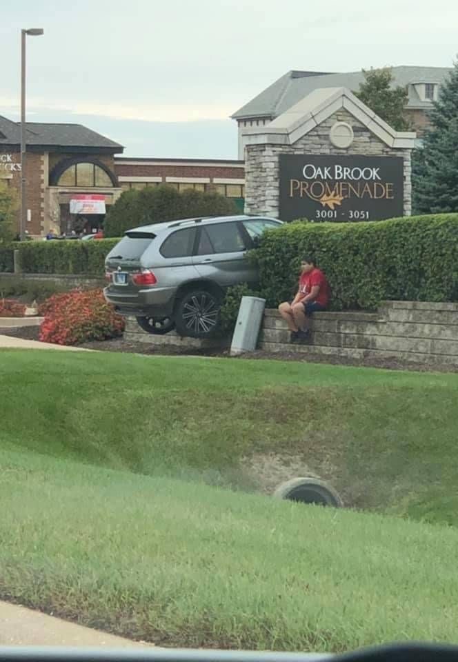 Car Parked on Top of a Fence
