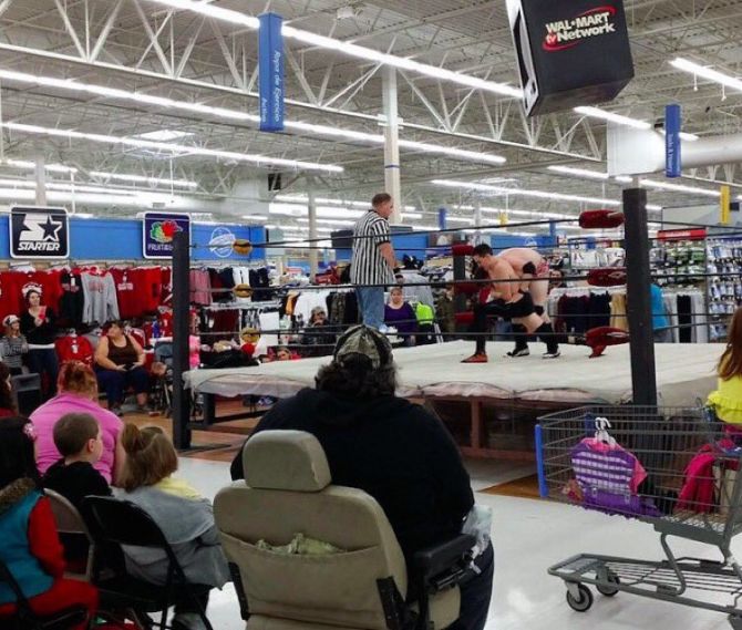 Wrestling match with ref taking place inside a Wal-Mart