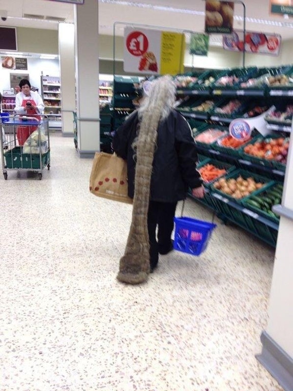 Man shopping with long dirty hair that is dragging on the floor.