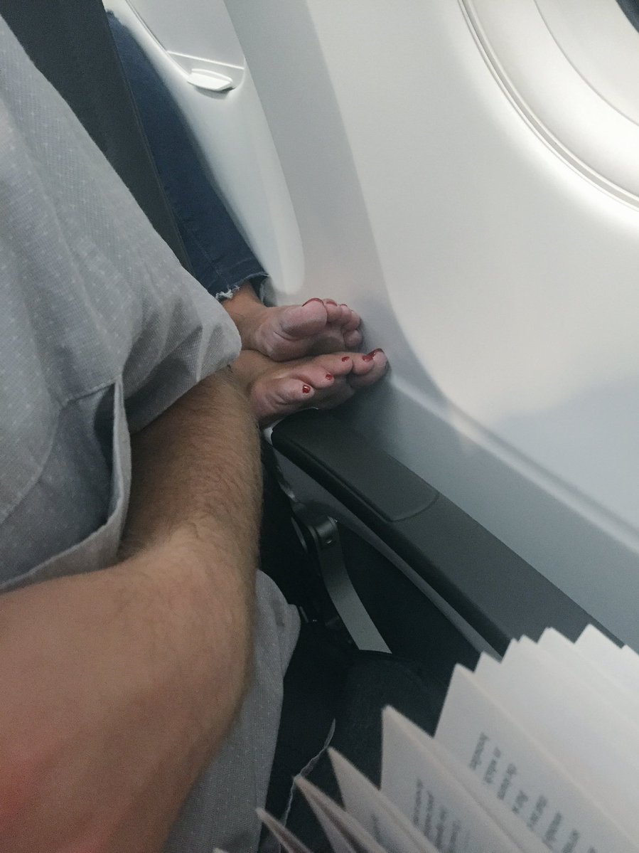 Someone sticking their feet where they don't belong on an airplane.
