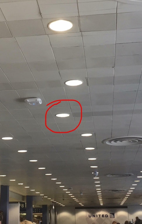 Light at the United Airlines terminal which has one lone light out of pattern from the rest.
