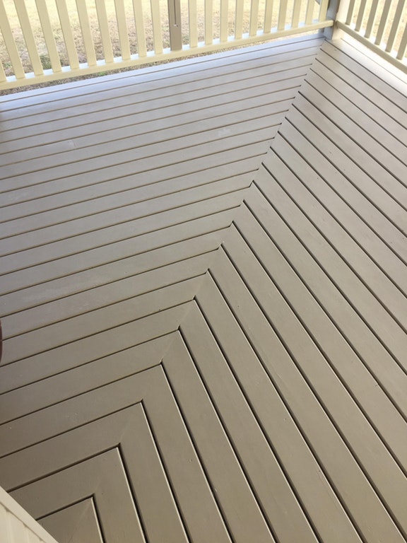 Wooden deck that is off kilter in a very trippy corner pattern.