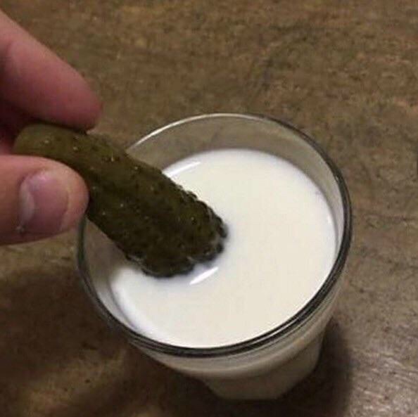 cursed image of dipping a pickle in milk