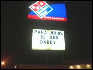 picture of dominos pizza sign saying papa johns is our daddy