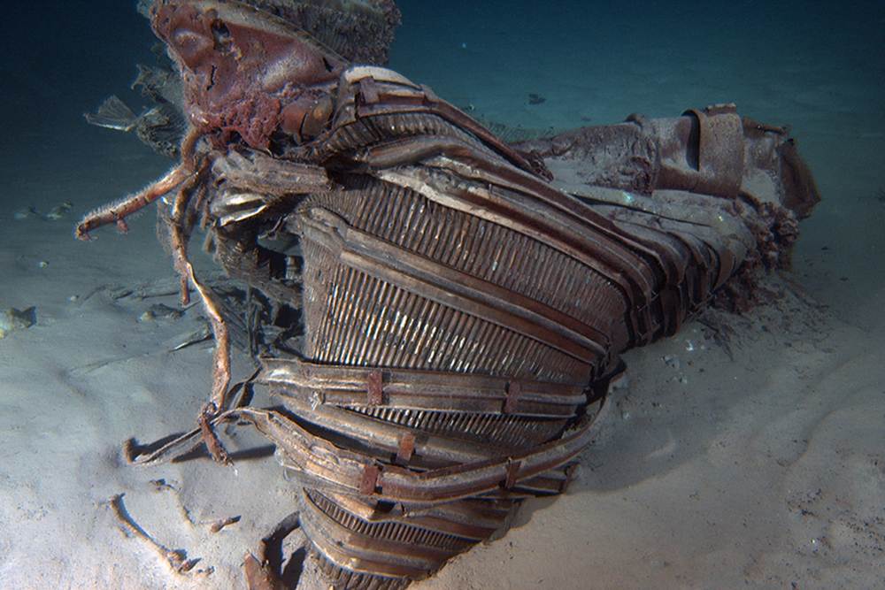 A crumpled rocket engine nozzle lies on the ocean floor. The Saturn 5's first stage fired its engines for two and a half minutes after launch, and then was jettisoned to let the second stage take over during ascent