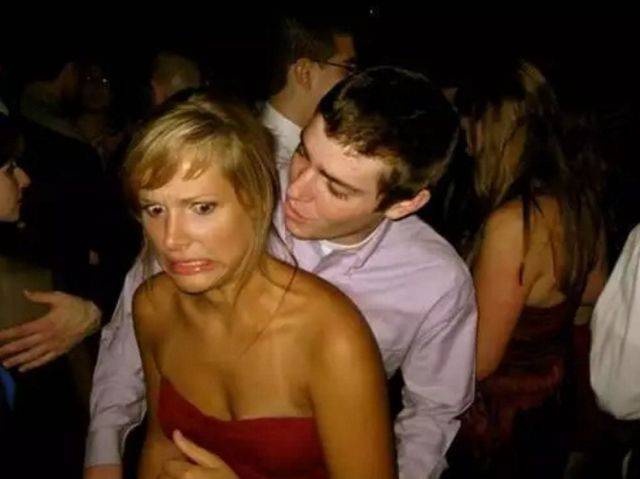 random picture of younger man dancing and grabbing older woman on the dance floor with her priceless expression