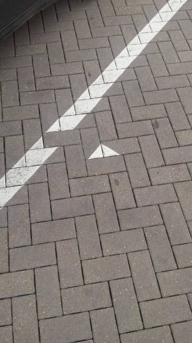 random internet pic of a mildly infuriating misplaced brick in the sidewalk