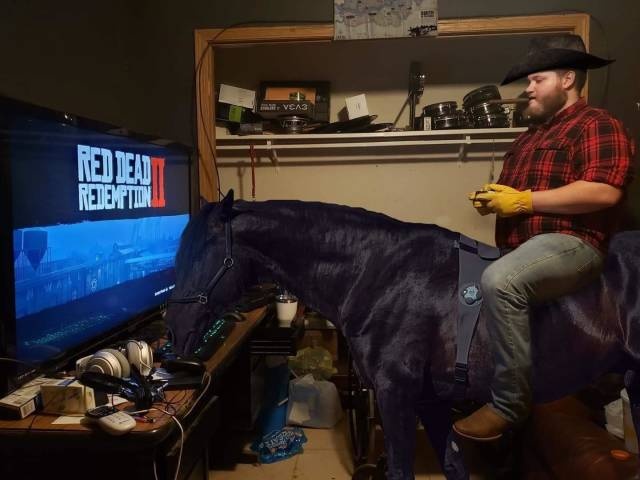man on a real horse playing red dead redemption 2 on his big screen