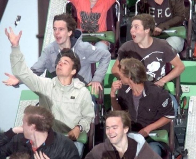funny picture of guys posing on a roller coaster