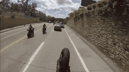 funny gif of a cheeky motorcyclist getting caught by a cop