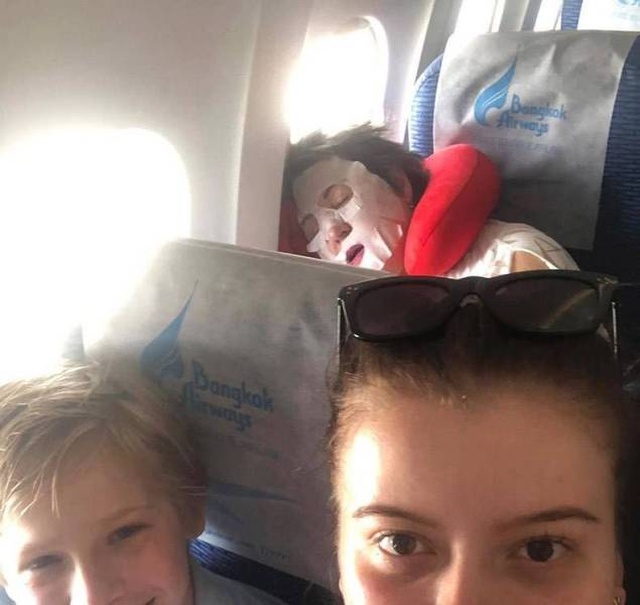 funny picture of a person sleeping on a plane with a face mask