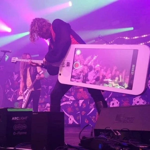 funny picture of a musician playing a smartphone guitar