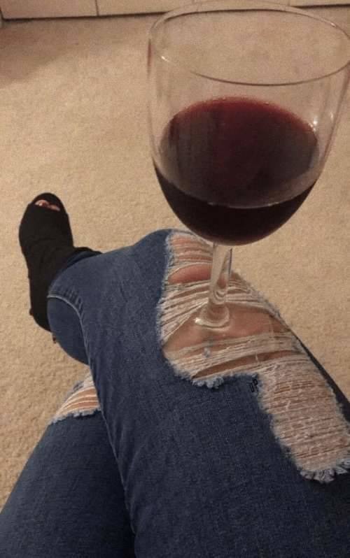 ripped jeans with wine glass