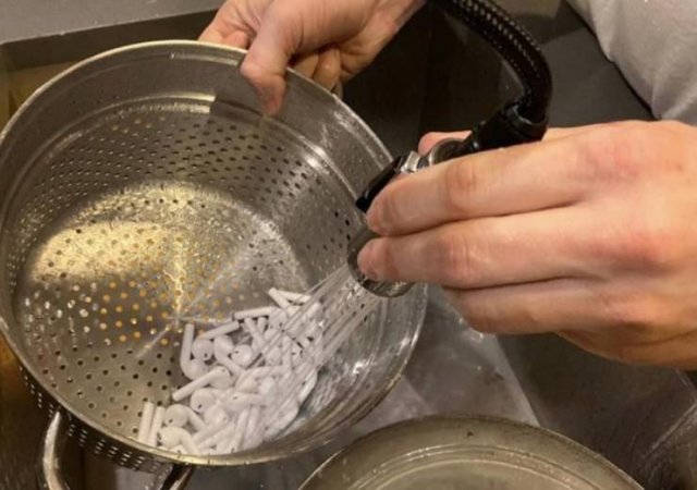 washing a bunch of airpods in a sink