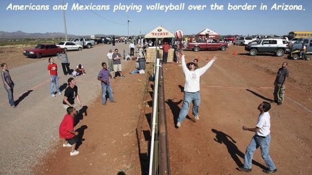 americans and mexicans - Americans and Mexicans playing volleyball over the border in Arizona.