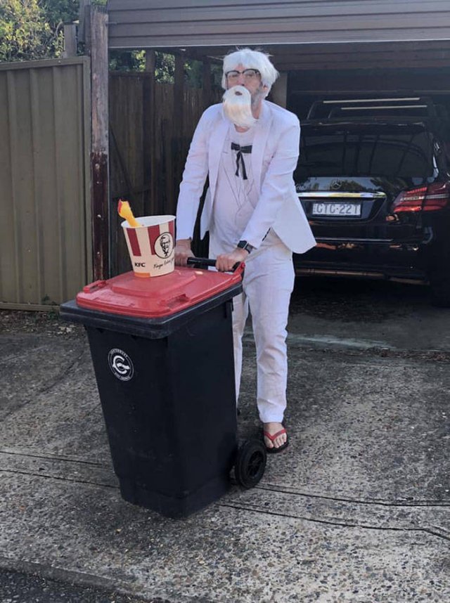 man dressed as kfc colonel sanders taking out the trash