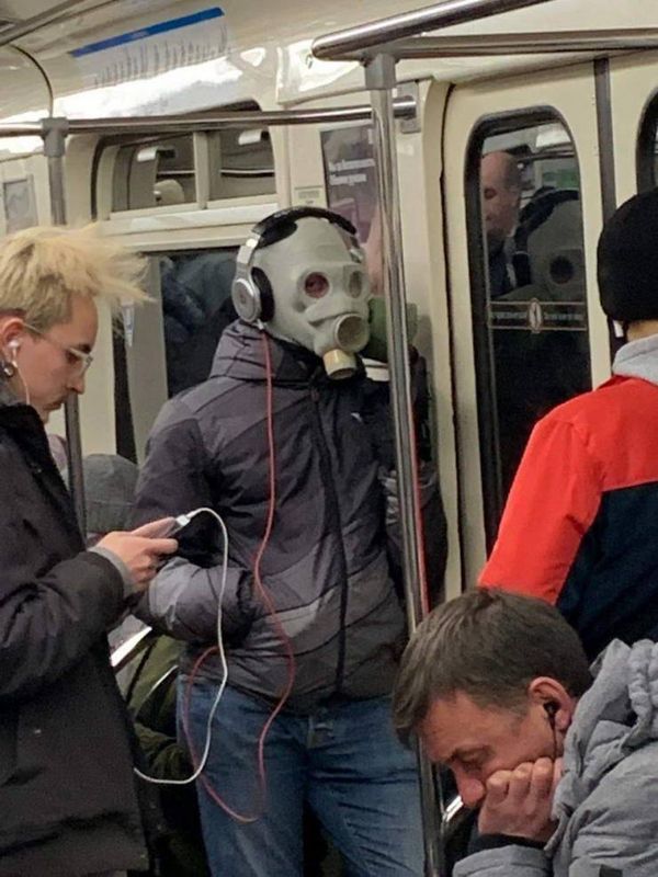 guy on train wearing full face gas mask