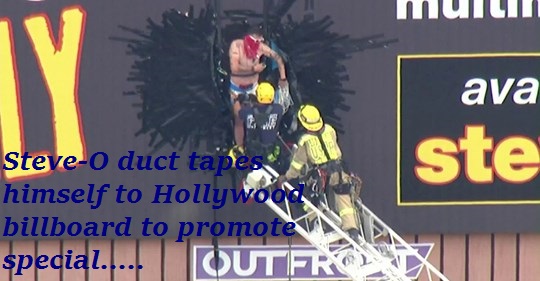 banner - ava ste Steveo duct tapes himself to Hollywood billboard to promote special..... Outfr