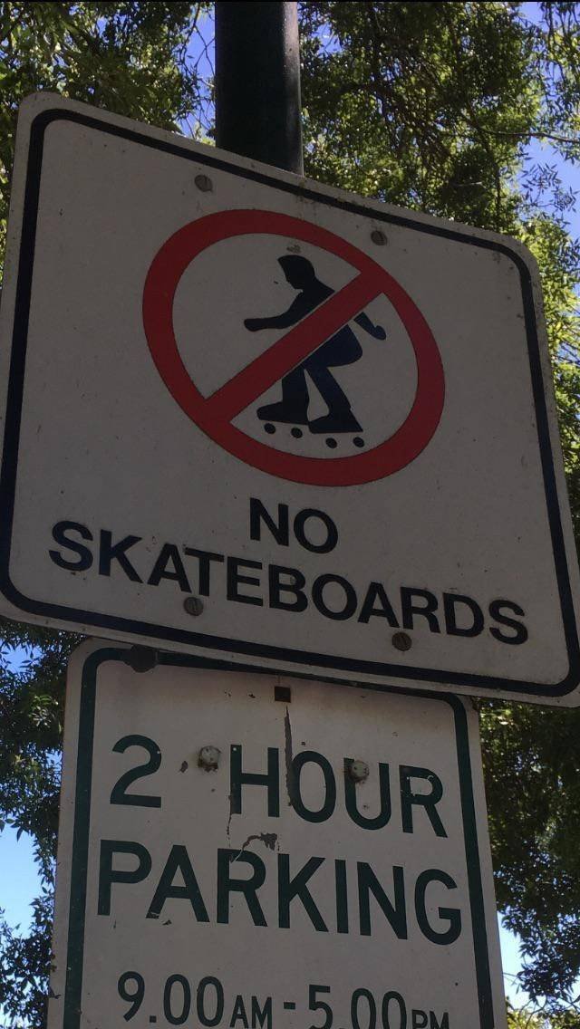 street sign - No Skateboards 2 Hour Parking 9.00AM5.00PM
