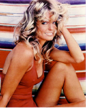 1976 - Farrah Fawcett-Majors poses for a poster in her swimsuit, inspiring bad hairstyles, anorexia and palm callouses around the globe.